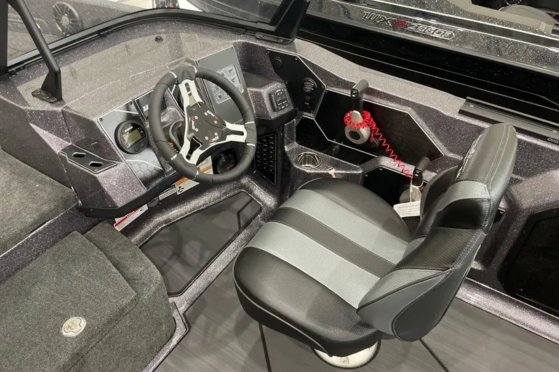 Slide: The Image of 2026 Skeeter WXR2060 boat cockpit with steering wheel and seat. - 19