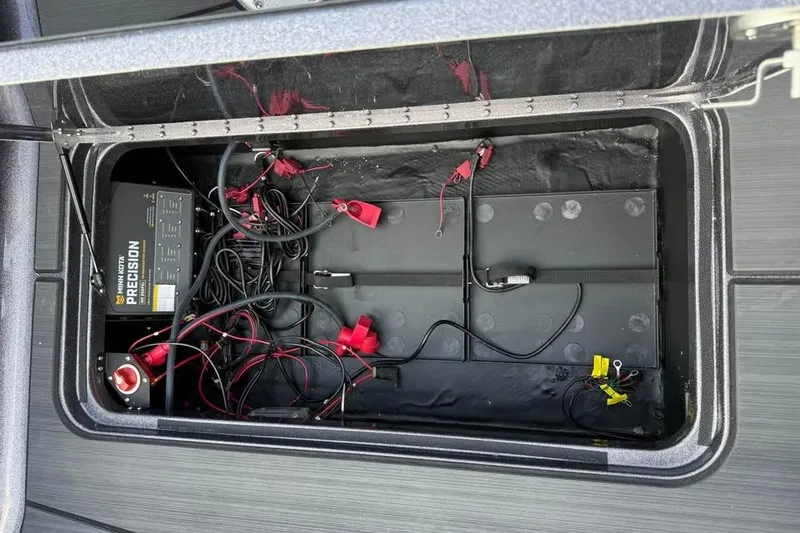 Slide: The Image of Battery compartment of 2026 Skeeter WXR2060 with Minn Kota Precision charger and wiring. - 25