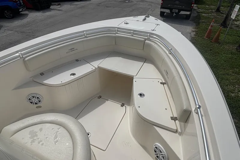 Slide: The Image of 2022 Cobia 237 Center Console boat interior with cushioned seating and storage compartments. - 10