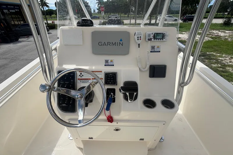 Slide: The Image of 2022 Cobia 237 Center Console helm with Garmin navigation and control panel. - 13