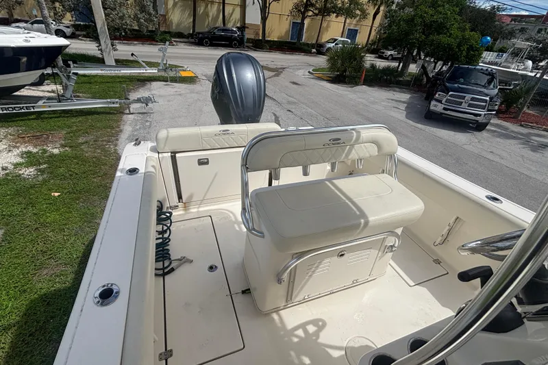 Slide: The Image of 2022 Cobia 237 Center Console boat interior with seating and engine view. - 15