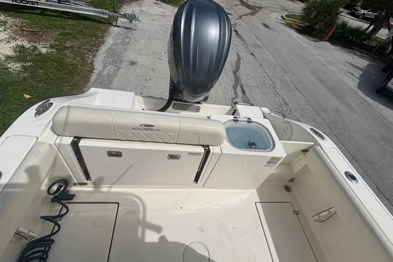 Slide: The Image of 2022 Cobia 237 Center Console boat with outboard motor and seating area. - 16