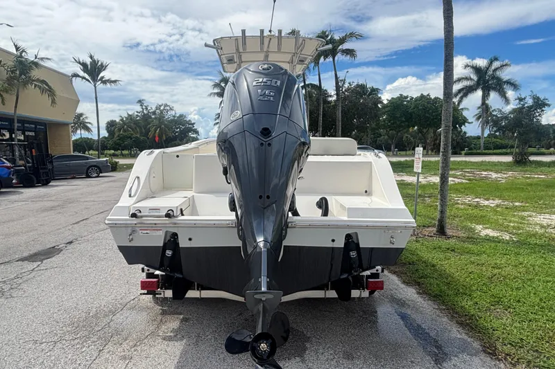 Slide: The Image of 2022 Cobia 237 Center Console boat with powerful outboard motor, parked outdoors. - 4