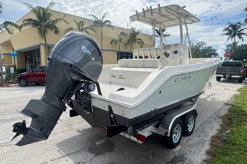 Slide: The Image of 2022 Cobia 237 Center Console boat with Yamaha engine on trailer, parked outdoors. - 5