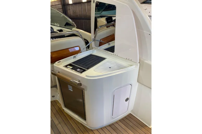 Slide: The Image of 2026 Chris-Craft Launch 31 GT boat interior with kitchenette and wooden accents. - 8