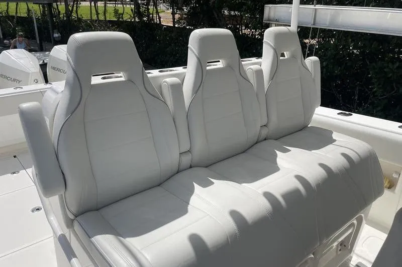 Slide: The Image of White leather seating on a 2022 SeaVee 370z boat, featuring three ergonomic seats. - 13