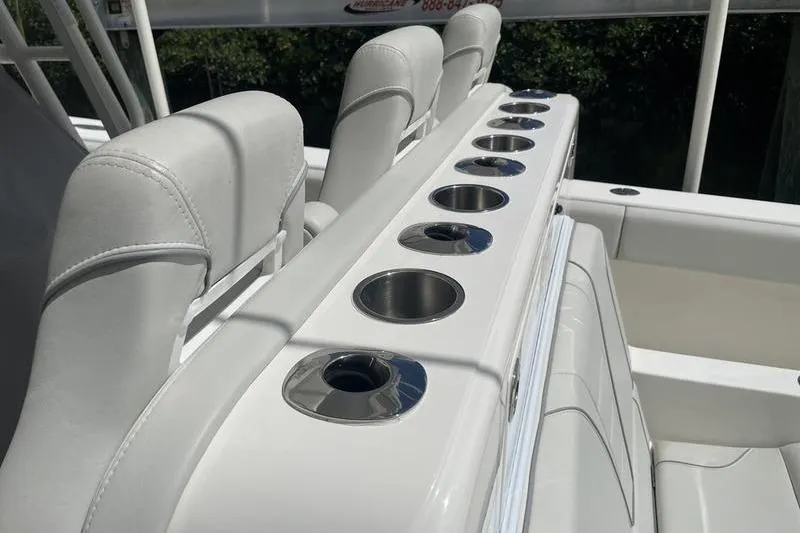 Slide: The Image of 2022 SeaVee 370z boat interior with white seating and multiple stainless steel cup holders. - 15