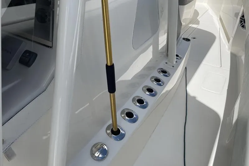Slide: The Image of 2022 SeaVee 370z boat deck with rod holders and sleek white finish. - 17