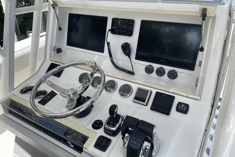 Slide: The Image of Control panel of 2022 SeaVee 370z boat with steering wheel and electronic displays. - 19
