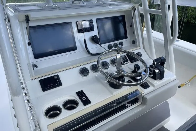 Slide: The Image of Control panel of a 2022 SeaVee 370z boat with steering wheel and navigation screens. - 20