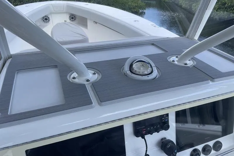 Slide: The Image of 2022 SeaVee 370z boat dashboard with compass and control panel. - 23