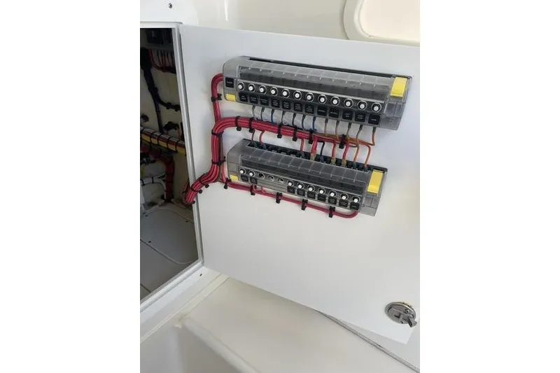 Slide: The Image of Electrical panel inside 2022 SeaVee 370z boat, featuring organized wiring and labeled switches. - 29