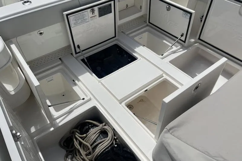 Slide: The Image of 2022 SeaVee 370z boat storage compartments with open hatches and coiled ropes. - 7
