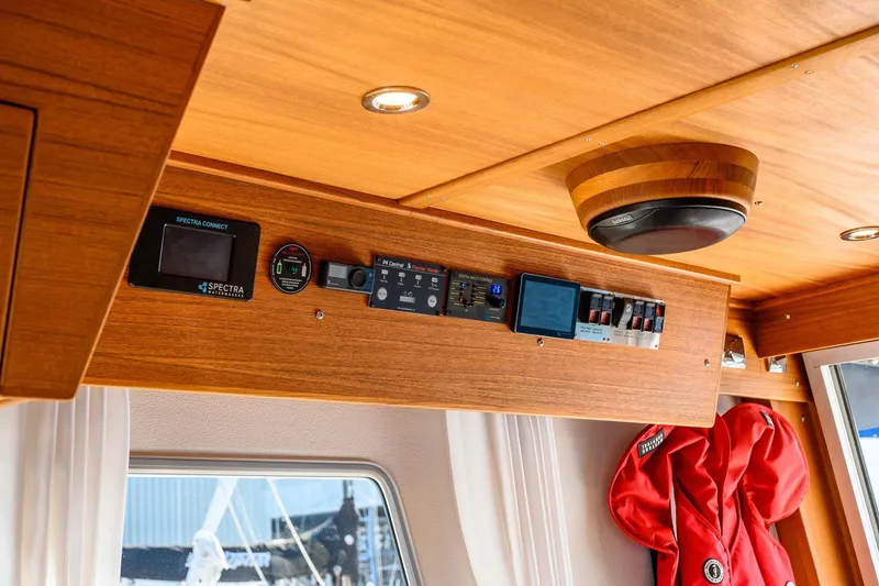 Slide: The Image of 2024 Targa 37 interior control panel with wooden finish and modern equipment. - 16