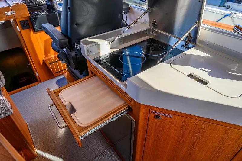 Slide: The Image of 2024 Targa 37 yacht interior with modern kitchen and wooden cabinetry. - 18