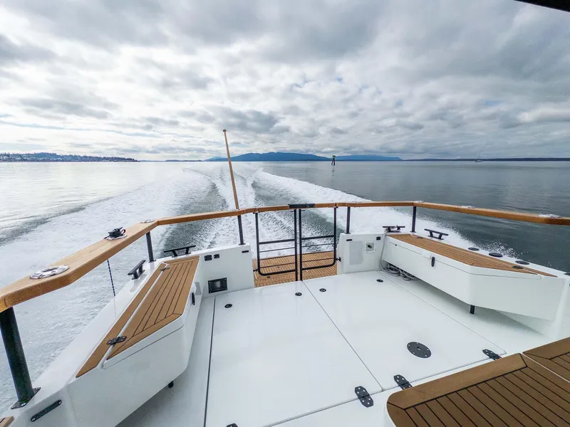 Slide: The Image of 2024 Targa 37 boat cruising on calm waters under a cloudy sky. - 21