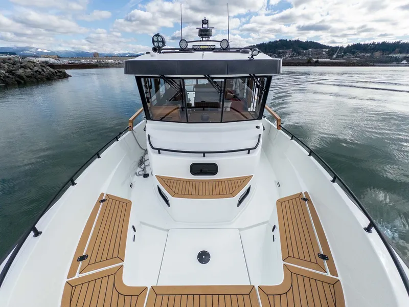 Slide: The Image of 2024 Targa 37 boat with sleek design, wooden deck accents, and modern cabin on calm waters. - 29