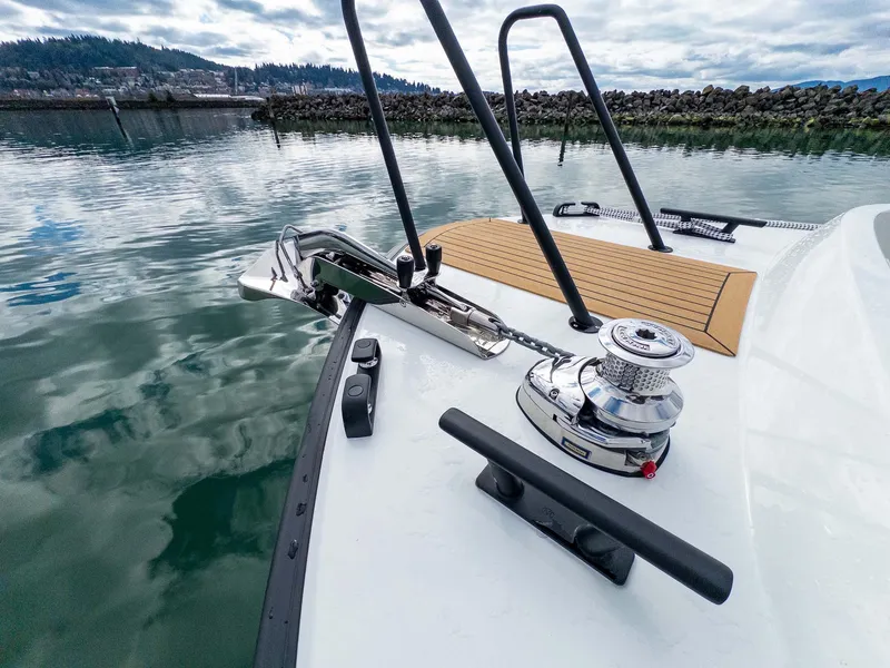Slide: The Image of 2024 Targa 37 boat deck with anchor and winch, docked in calm waters. - 31
