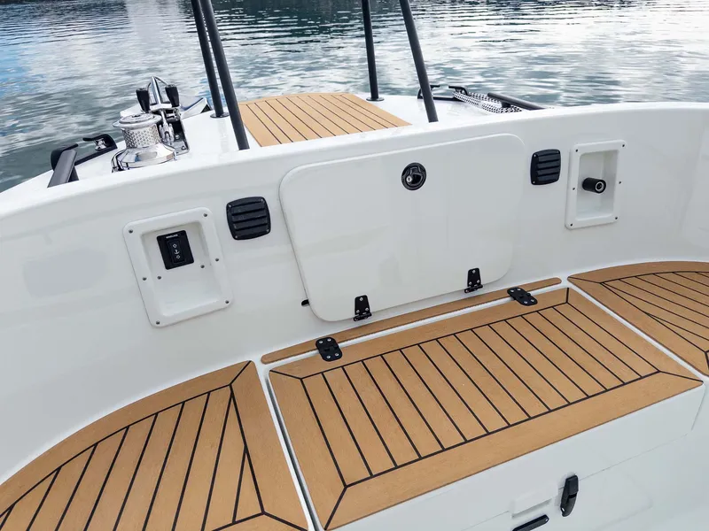 Slide: The Image of 2024 Targa 37 boat deck with teak flooring, featuring storage compartments and sleek design. - 32