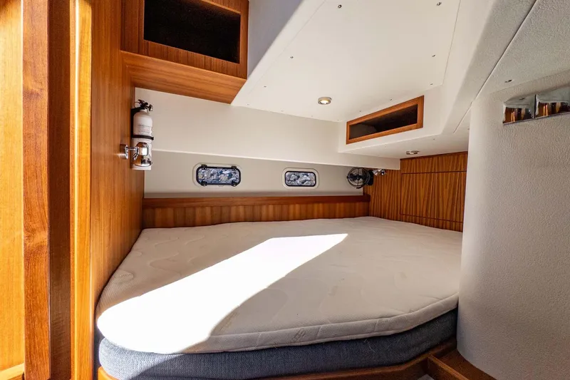 Slide: The Image of 2024 Targa 37 cabin interior with wooden finish and cozy bed. - 34