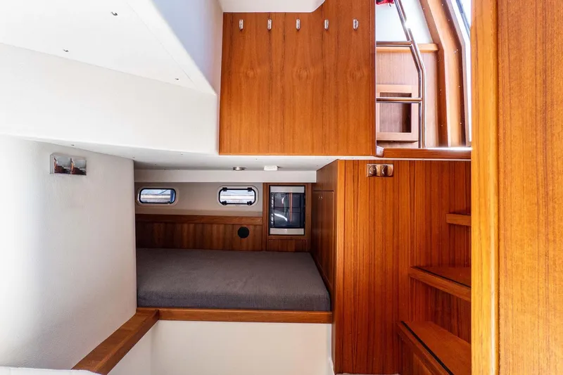 Slide: The Image of 2024 Targa 37 interior cabin with wooden finish and cozy sleeping area. - 38