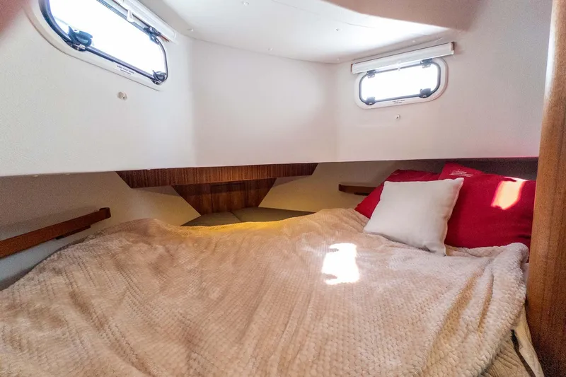 Slide: The Image of Cozy cabin interior of 2024 Targa 37 boat with comfortable bedding and natural light. - 40