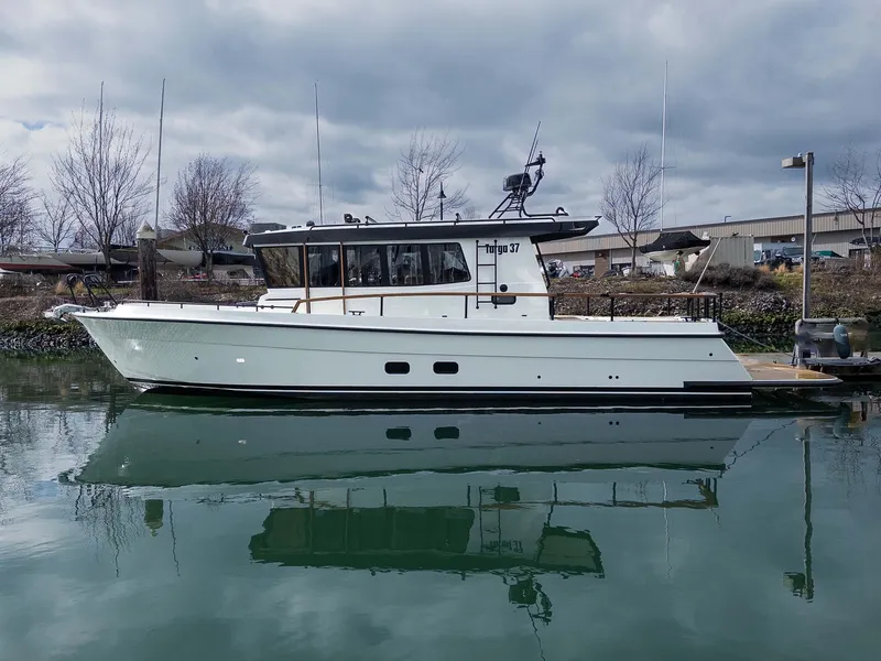Slide: The Image of 2024 Targa 37 boat docked on calm water under cloudy skies. - 46