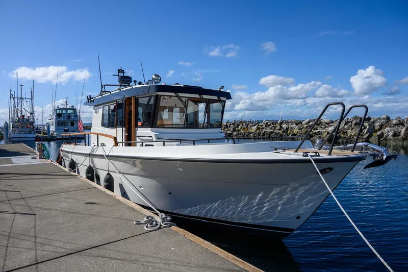 Slide: The Image of 2024 Targa 37 boat docked at a marina under a clear blue sky. - 47