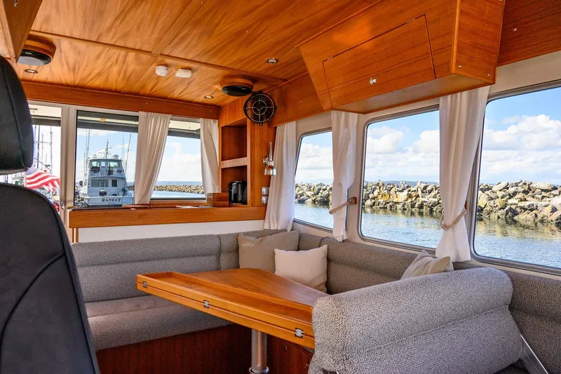 Slide: The Image of Interior of 2024 Targa 37 boat with wooden accents and scenic window views. - 5
