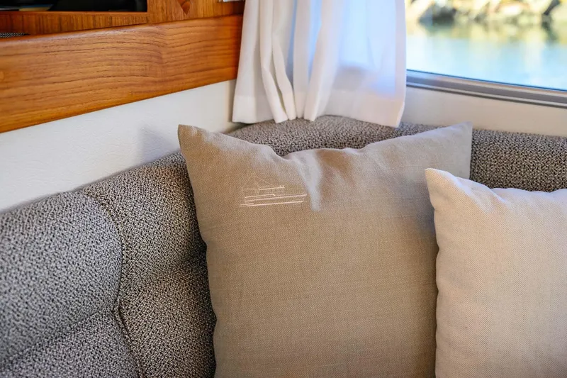 Slide: The Image of Cozy interior of 2024 Targa 37 with decorative cushions and wooden accents. - 8