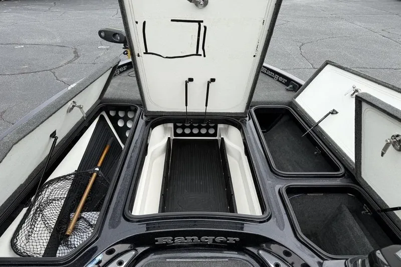 Slide: The Image of 2015 Ranger Z520 Comanche boat storage compartments with fishing gear and open hatches. - 10