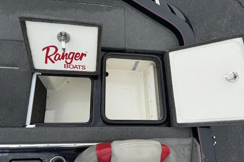 Slide: The Image of 2015 Ranger Z520 Comanche boat storage compartments with open lids. - 19