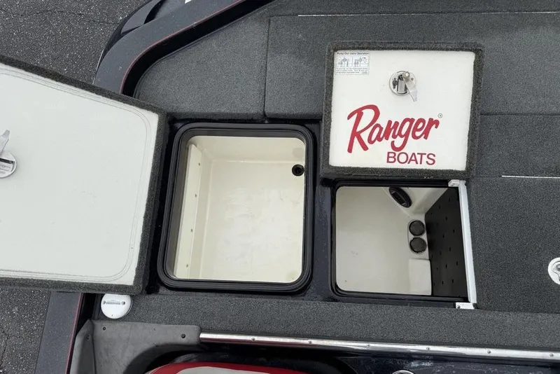 Slide: The Image of 2015 Ranger Z520 Comanche boat storage compartments with open lids. - 21
