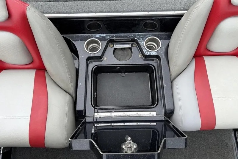 Slide: The Image of 2015 Ranger Z520 Comanche boat interior with red and gray seats, open storage compartment. - 7