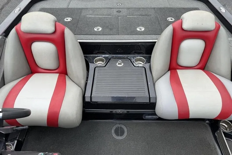 Slide: The Image of 2015 Ranger Z520 Comanche boat interior with red and white seats, cup holders, and storage. - 9