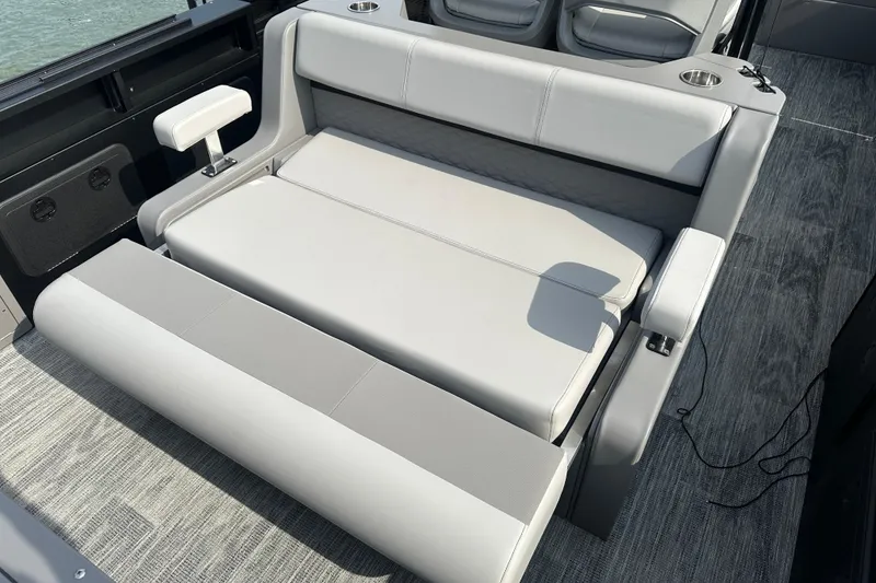 Slide: The Image of Luxurious seating on 2026 Qwest M-Class 24 Pro Sport boat, featuring sleek gray upholstery. - 11