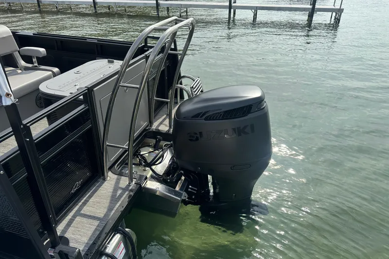 Slide: The Image of 2026 Qwest M-Class 24 Pro Sport boat with Suzuki outboard motor on water. - 8