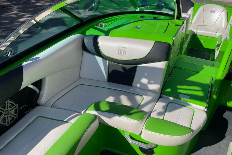 Slide: The Image of 2013 MasterCraft XStar boat interior with green and white seating. - 10