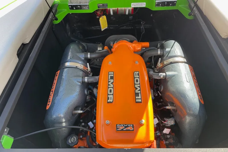 Slide: The Image of 2013 MasterCraft XStar engine with orange Ilmor cover, showcasing powerful performance. - 14