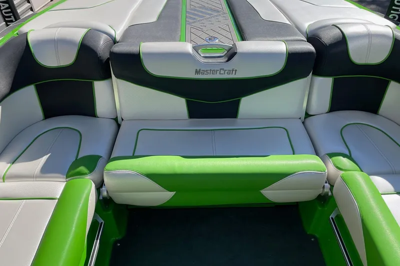 Slide: The Image of 2013 MasterCraft XStar boat interior with green and white seating. - 8