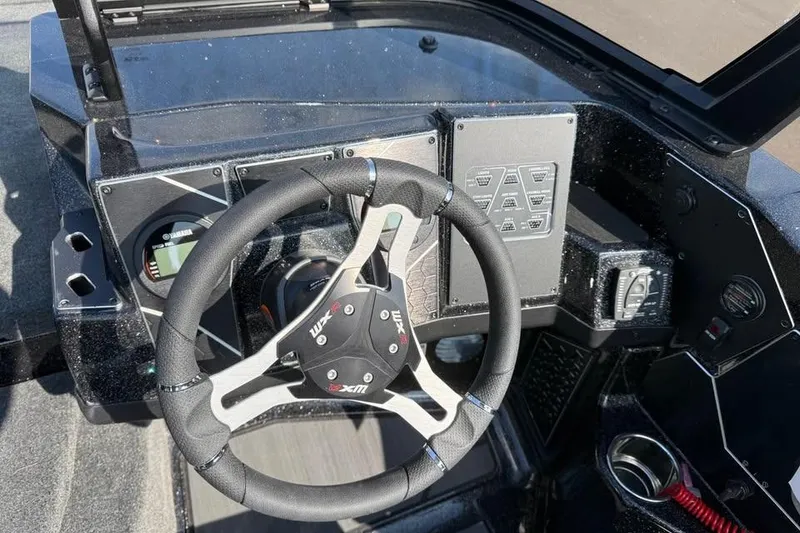 Slide: The Image of 2026 Skeeter WXR2060 F boat dashboard with steering wheel and control panel. - 10