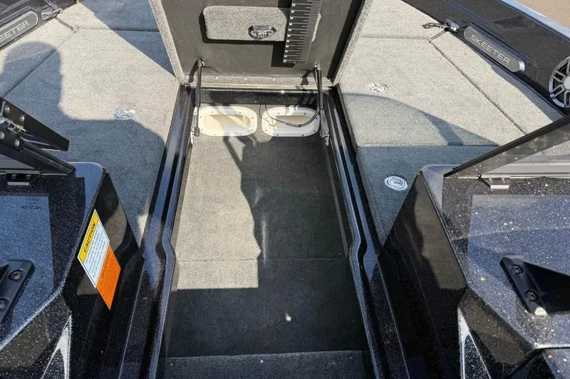Slide: The Image of Interior view of 2026 Skeeter WXR2060 F boat, showcasing storage compartments and seating area. - 11