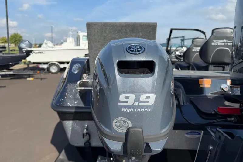 Slide: The Image of 2026 Skeeter WXR2060 F boat with 9.9 high thrust motor in a marina setting. - 19