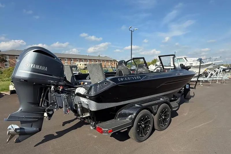 Slide: The Image of 2026 Skeeter WXR2060 F boat with Yamaha engine on trailer in parking lot. - 2
