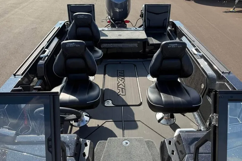 Slide: The Image of 2026 Skeeter WXR2060 F boat interior with four black seats and sleek design. - 24