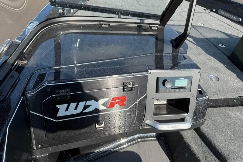 Slide: The Image of 2026 Skeeter WXR2060 F boat dashboard with control panel and storage compartment. - 9
