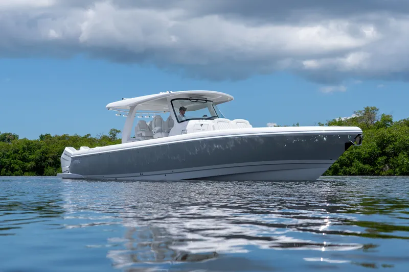 Slide: The Image of Intrepid 43 Nomad SE 2026 on calm water under cloudy sky. - 0