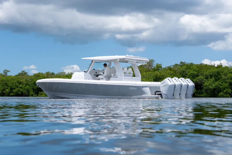 Slide: The Image of Intrepid 43 Nomad SE 2026 on calm water, cloudy sky. - 1
