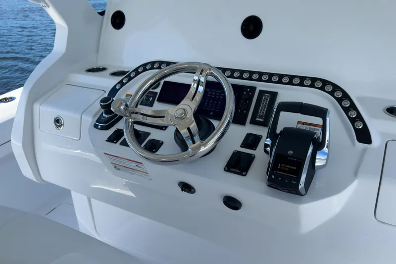 Slide: The Image of Intrepid 43 Nomad SE 2026 helm console on open water. - 11