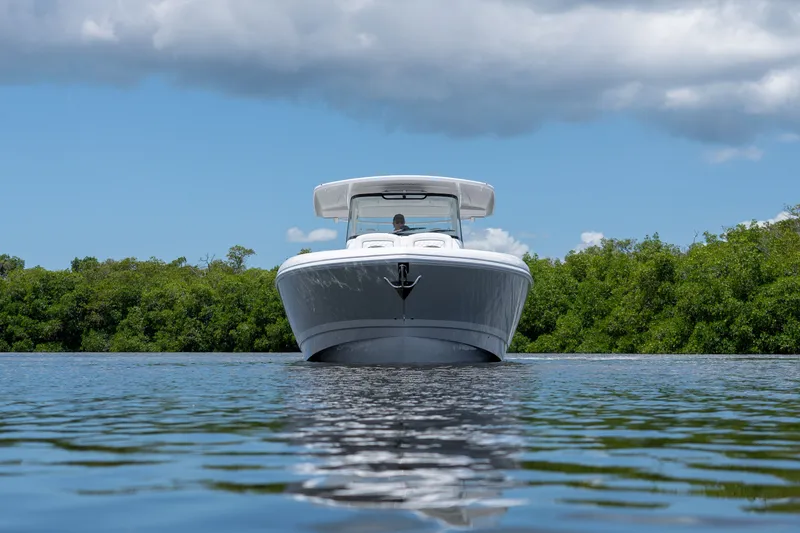 Slide: The Image of Intrepid 43 Nomad SE 2026 on calm water with green backdrop. - 21